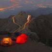 two tents sitting on top of a mountain at night