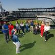 a group of people standing on a field at a baseball game