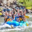 a group of people on a raft on a river