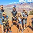 a family posing for a picture at the grand canyon