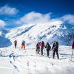 a group of people skiing on a snow covered mountain