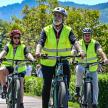 a group of people riding bikes down a road