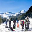 a group of people standing on a snow covered mountain