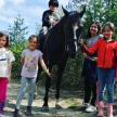 a group of children standing next to a horse