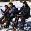 a group of people sitting on bikes in the snow