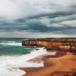 a view of a beach with a cloudy sky and the ocean