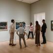 a group of people looking at art in a museum