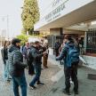 a group of people standing outside of a store