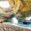 a group of people on a boat in a cave