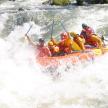 a group of people in a raft in a river