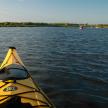 a group of people in kayaks on a lake
