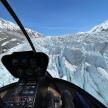 a view of a glacier from the inside of a helicopter