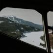 a view of a snowy mountain from an airplane window