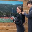 two people in wet suits standing in front of a painting