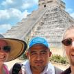 a group of people standing in front of the pyramid