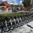 a row of bikes parked next to a street