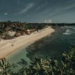 a beach with a group of people and the ocean