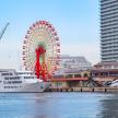 a ferris wheel and a cruise ship in the water