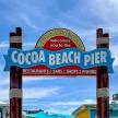 a sign that says cocacola beach pier