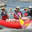 a group of people in a raft on a river