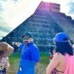a group of people standing in front of a pyramid
