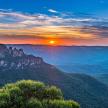 a view of the blue mountains at sunset