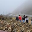a group of people standing on top of a pile of rocks