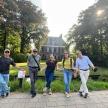 a group of people walking in front of a house