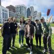 a group of people posing for a picture in a park