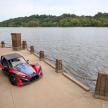 a car parked on a dock next to a body of water