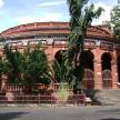 a large brick building with stairs in front of it