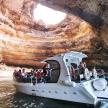 a group of people on a boat in a cave