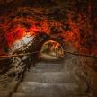 a staircase in a cave with red fire on it