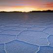 an image of a cracked desert field at sunset