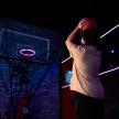 a man holding a basketball in front of a basketball hoop