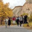 a group of people jumping in front of some rocks