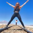 a woman standing on tracks in the desert