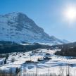 a snow covered slope with a mountain in the background