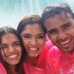 a group of three people in the rain