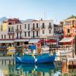 a group of boats docked in a harbor with buildings