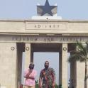 a man and a woman standing in front of a monument