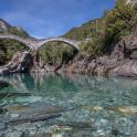 a bridge over a river with rocks and water