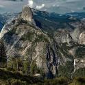 a large rocky mountain with trees and mountains