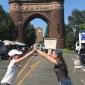 two girls giving each other a high five in front of an arch