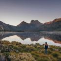 a man standing in front of a body of water