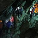 a group of people are climbing in a cave