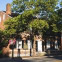 a brick building with trees in front of it