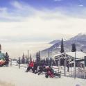 a group of people in the snow at a ski slope