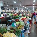 a market filled with lots of fruits and vegetables