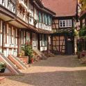 a courtyard of an old building with wooden doors